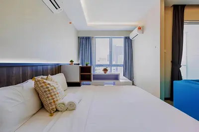 a bedroom with a large white bed with a large window at Mansion One l 5pax Studio l Seaview & Cityview l Georgetown l by PerfectSweetHome in George Town