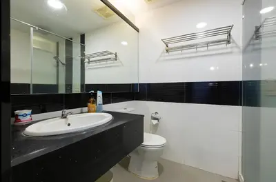a bathroom with a sink and a toilet and a mirror at Mansion One l 5pax Studio l Seaview & Cityview l Georgetown l by PerfectSweetHome in George Town