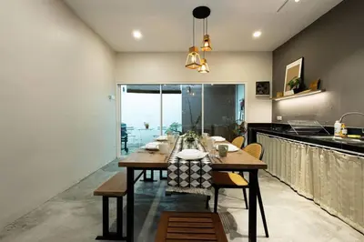 a dining room with a table and a large window at InWood - Pet allow Ipoh homestay & BBQ in Ipoh
