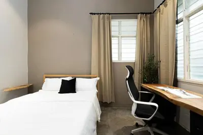 a bedroom with a bed and a desk and a chair at InWood - Pet allow Ipoh homestay & BBQ in Ipoh