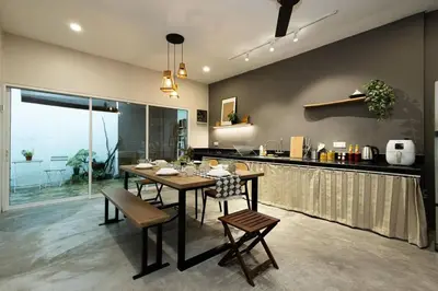 a kitchen with a table and chairs and a counter at InWood - Pet allow Ipoh homestay & BBQ in Ipoh