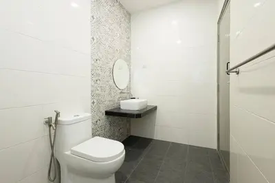 a white bathroom with a toilet and a mirror at InWood - Pet allow Ipoh homestay & BBQ in Ipoh