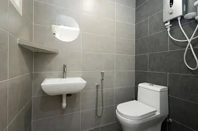a bathroom with a toilet and a sink and a mirror at InWood - Pet allow Ipoh homestay & BBQ in Ipoh