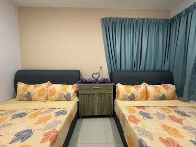 two beds in a room with blue curtains at Premium Manhattan Ipoh \u6021\u4fdd\u6c11\u5bbf, 4bedroom 12pax, water park in Ipoh