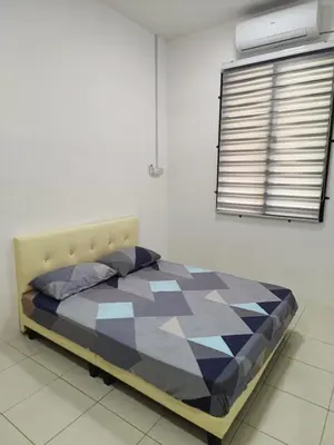 a bedroom with a bed in a room with a window at Rumah SK in Batu Kurau