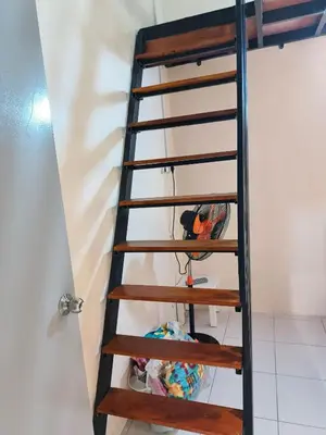 a ladder leading up to a room at Rumah SK in Batu Kurau