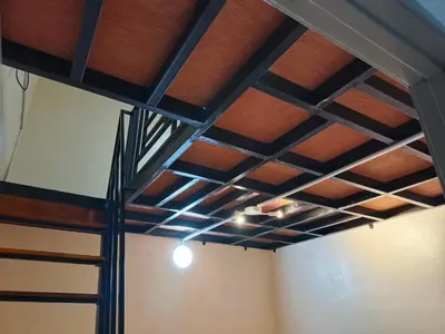 a ceiling in a room with wood and metal at Rumah SK in Batu Kurau