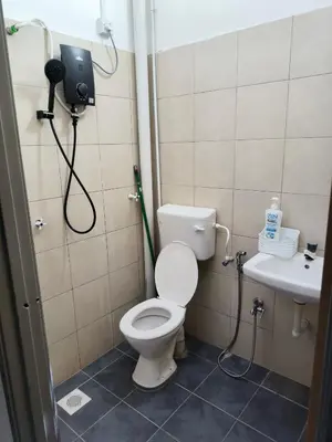 a bathroom with a toilet and a sink at Rumah SK in Batu Kurau