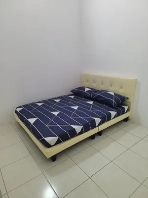 a bed in a room with a blue and white at Rumah SK in Batu Kurau