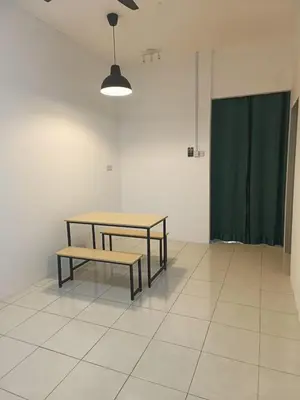 a table and bench in a room with a green curtain at Rumah SK in Batu Kurau