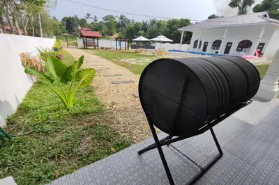 a black fan sitting on the side of a house at Grand Aeden Villa in Kuala Kangsar