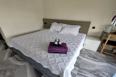 a bedroom with a bed with two candles on it at Grand Aeden Villa in Kuala Kangsar