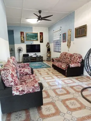 a living room with two couches and a flat screen tv at Homestay Mariah in Ipoh