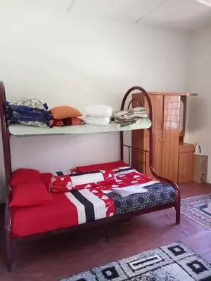a bedroom with a bed with a shelf on it at Homestay Mariah in Ipoh
