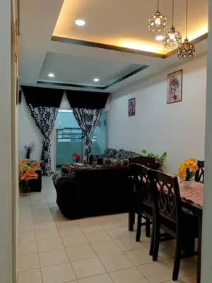 a living room with a couch and a table at Mateen Cottage II in Tanah Rata