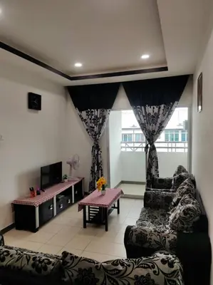a living room with a couch and a table at Mateen Cottage II in Tanah Rata