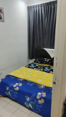 a small bedroom with a bed and a window at Mateen Cottage II in Tanah Rata