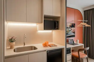 a small kitchen with a sink and a microwave at Citadines Tanjung Tokong Penang in George Town