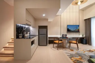 a kitchen and living room with a table and a counter at Citadines Tanjung Tokong Penang in George Town