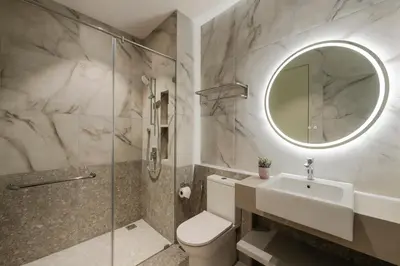 a bathroom with a toilet and a sink and a mirror at Citadines Tanjung Tokong Penang in George Town