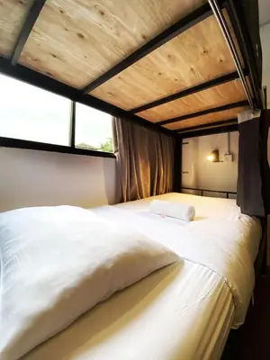 a large white bed in a room with a window at Pine Armenian in George Town