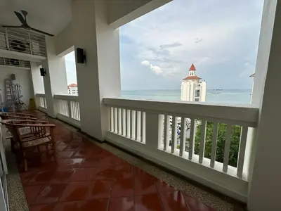 a balcony with a view of the ocean at 2 bedroom Suite with Sea View At Straits Quay in Tanjong Tokong