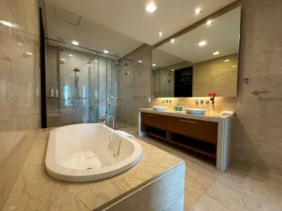 a large bathroom with a tub and a shower at 2 bedroom Suite with Sea View At Straits Quay in Tanjong Tokong