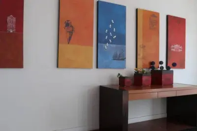 a room with paintings on the wall and a table at 2 bedroom Suite with Sea View At Straits Quay in Tanjong Tokong