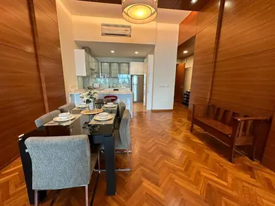 a kitchen and dining room with a table and chairs at 2 bedroom Suite with Sea View At Straits Quay in Tanjong Tokong