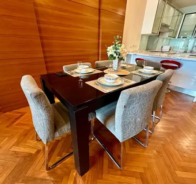 a dining room with a table and chairs at 2 bedroom Suite with Sea View At Straits Quay in Tanjong Tokong