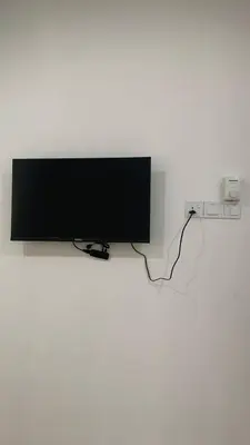 a flat screen tv hanging on a wall at Bilik Naqiah in Gerik