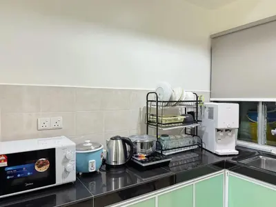 a kitchen with a counter top with a microwave at Sekinchan 2008 Home \u60a6\u5ba2 \u76d0\u7cfb\u5976\u5496\u98ce\u6c11\u5bbf in Sekincan