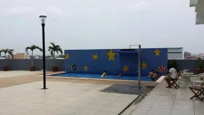 a blue wall with stars on it with people in a pool at Sekinchan 2008 Home \u60a6\u5ba2 \u76d0\u7cfb\u5976\u5496\u98ce\u6c11\u5bbf in Sekincan