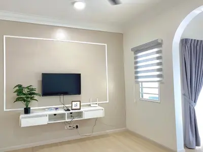 a living room with a tv on a wall at Sekinchan 2008 Home \u60a6\u5ba2 \u76d0\u7cfb\u5976\u5496\u98ce\u6c11\u5bbf in Sekincan