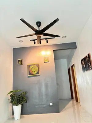 a ceiling fan in a living room with a plant at KH Homestay 2 Seri Manjung in Seri Manjung