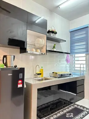 a kitchen with a sink and a stove top oven at KH Homestay 2 Seri Manjung in Seri Manjung