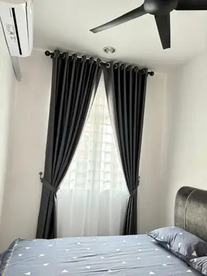 a bedroom with a black curtain and a window at KH Homestay 2 Seri Manjung in Seri Manjung