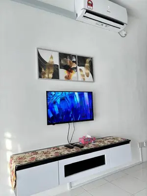 a flat screen tv sitting on a counter in a room at KH Homestay 2 Seri Manjung in Seri Manjung