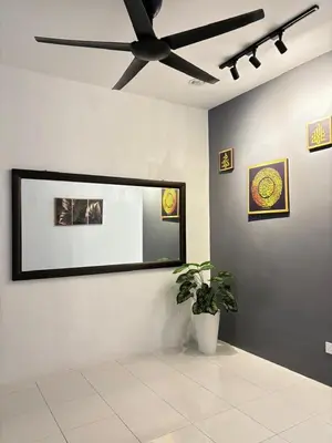 a room with a ceiling fan and a potted plant at KH Homestay 2 Seri Manjung in Seri Manjung