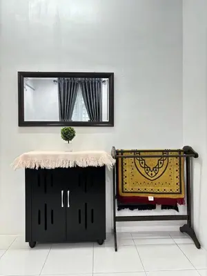 a mirror on a wall with a table and a rug at KH Homestay 2 Seri Manjung in Seri Manjung