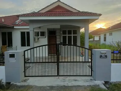 a house with a gate and a fence at Fatimah HomeStay Kulim Hi Tech in Kulim