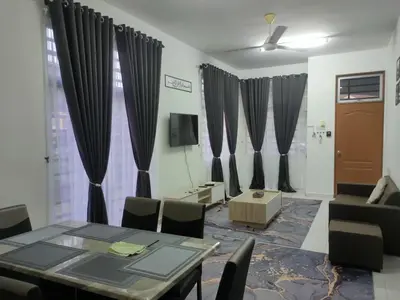 a dining room with a table and chairs and curtains at Fatimah HomeStay Kulim Hi Tech in Kulim