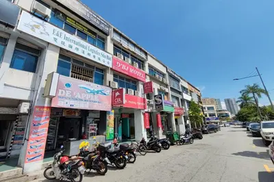 a row of motorcycles parked in front of a building at D'BJ Motel in Bayan Lepas