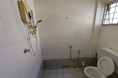 a bathroom with a toilet and a shower at D'BJ Motel in Bayan Lepas