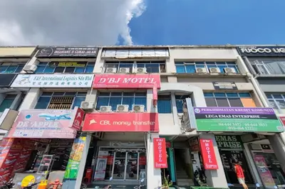 a building with signs on the front of it at D'BJ Motel in Bayan Lepas