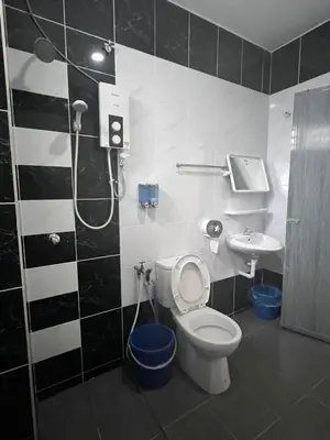 a bathroom with a shower and a toilet and a sink at \u73ed\u53f0\u6c11\u5bbf 185 in Pantai Remis