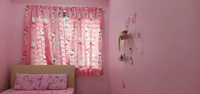 a bedroom with a pink curtain and a window at \u73ed\u53f0\u6c11\u5bbf 185 in Pantai Remis