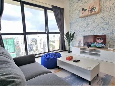 a living room with a couch and a tv at Skyblue 2 Rooms Apartment, 4 plus 2 Pax at Urban Suites in Jelutong