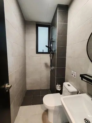 a bathroom with a toilet and a sink and a window at Skyblue 2 Rooms Apartment, 4 plus 2 Pax at Urban Suites in Jelutong