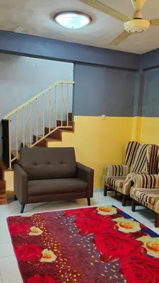 a living room with a couch and a rug at RS Homestay Gerik in Gerik